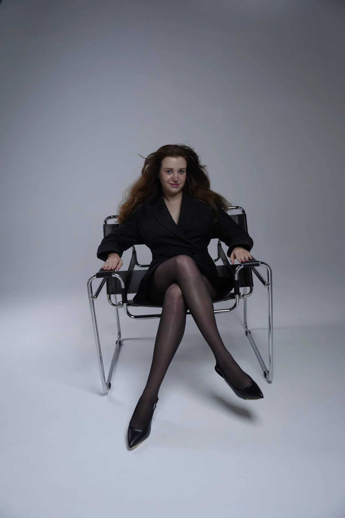 Studio portrait seated in a director’s chair