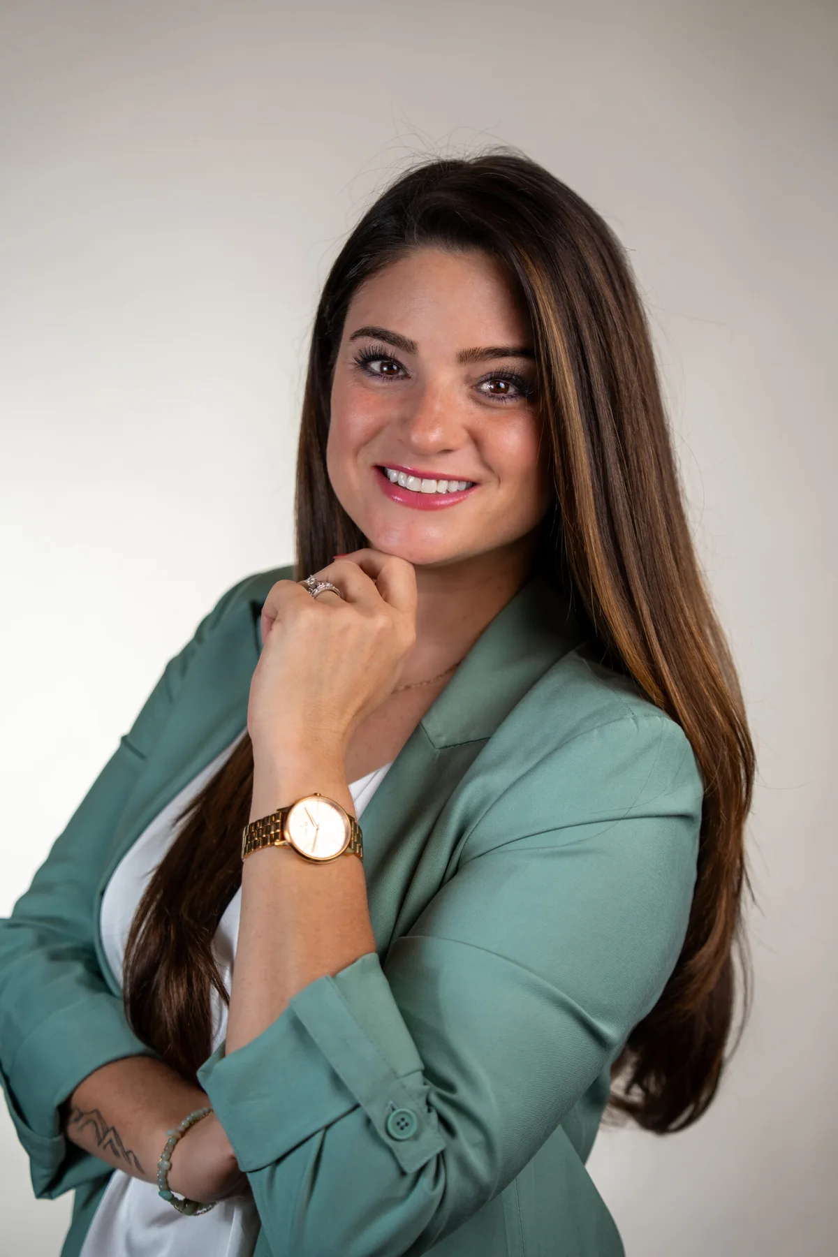 Professional headshot of a woman in a green blazer