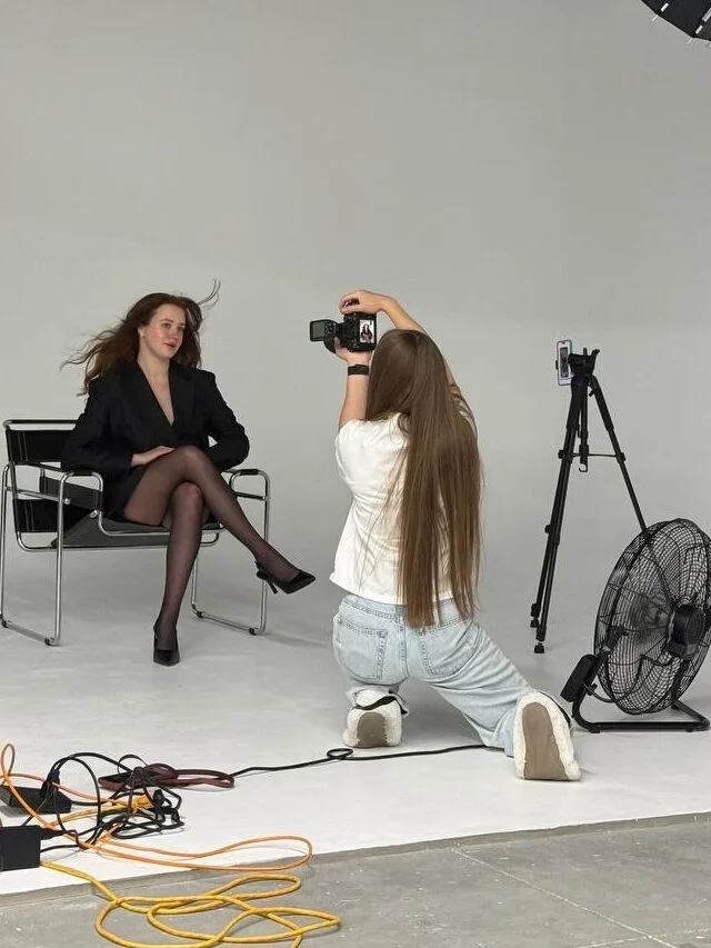 Lily working with a portrait client in the photography studio
